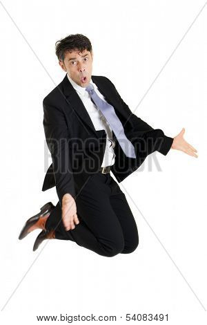 Businessman making an imploring impassioned gesture with outstretched arms while either kneeling on the floor or leaping in the air with his knees bent, isolated on white
