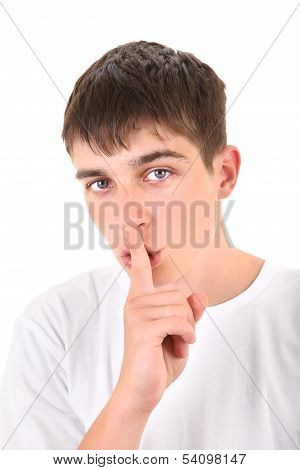 Teenager With Finger On His Lips