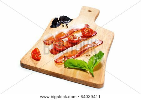 Dried Cherry Tomatoes With Bacon Served On Carving Board. Selective Focus. Italian Snack.