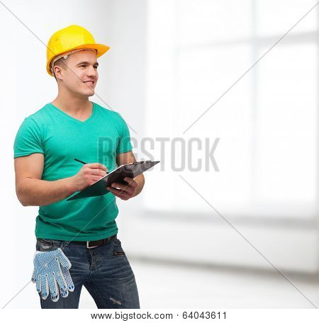 repair, construction and maintenance concept - smiling man in helmet with clipboard