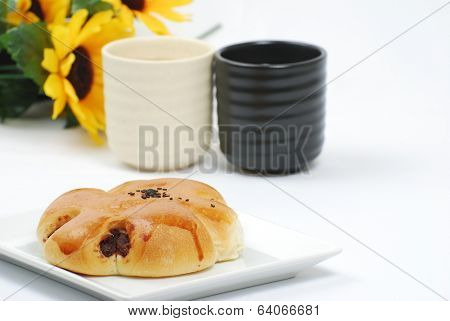 Chinese tea and red bean bread on white