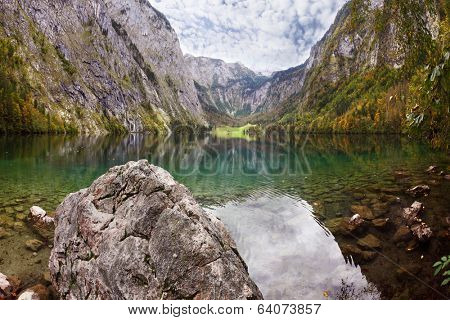  Fabulously beautiful lake Koenigssee. Cloudy sky reflected in lake
