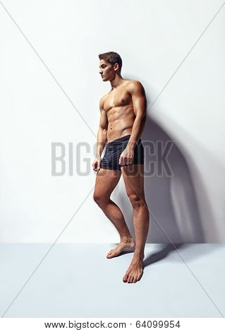 Muscular Man Leaning To White Wall