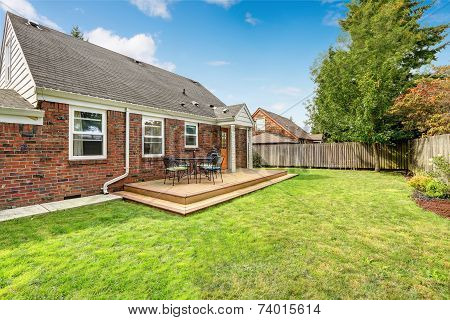 Brick House Exterior With Walkout Wooden Deck