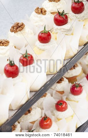 Little Cakes Decorated With Cherry Tomatoes And Walnuts