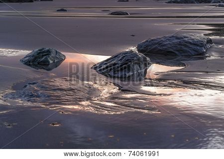 Stones On The Beach In Evening Light