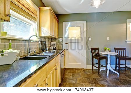 Kitchen Room With Maple Storage Cabinets And Dining Area