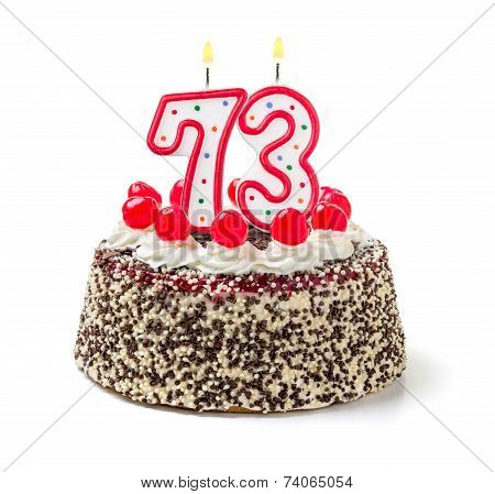 Birthday cake with burning candle number 73