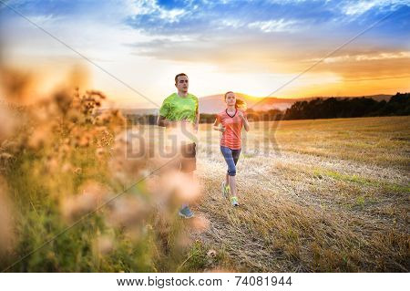 Couple running at sunset