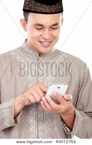 Young Muslim Man Typing On His Smartphone