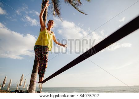 Teenage Girl  Balancing On Slackline With Sky View
