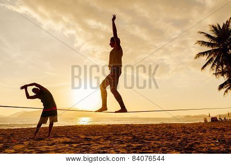 Teenagers Balance On Slackline Silhouette