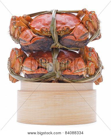 Hairy crabs on the Bamboo steamer Isolated in white background.