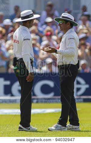 NOTTINGHAM, ENGLAND - July 13, 2013: umpires Kumar Dharmasena, and Aleem Dar have a discussion during day four of the first Investec Ashes Test match at Trent Bridge Cricket Ground