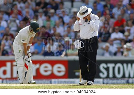 MANCHESTER, ENGLAND - August 02 2013: Umpire Marais Erasmus checks the bowlers foot marks during day one of  the Investec Ashes 3rd test match at Old Trafford Cricket Ground