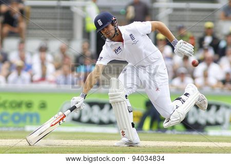MANCHESTER, ENGLAND - August 03 2013: Alastair Cook runs a single as the ball is thrown at the stumps during day three of  the Investec Ashes 3rd test match at Old Trafford Cricket Ground