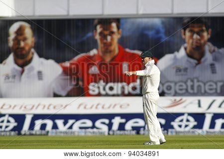 MANCHESTER, ENGLAND - August 02 2013: David Warner stands under a giant poster of Matt Prior, Steven Finn and Alastair Cook during day two of  the Investec Ashes 3rd test match