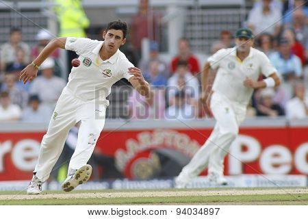 MANCHESTER, ENGLAND - August 03 2013: Mitchell Starc fields the ball off his bowling during day three of  the Investec Ashes 3rd test match at Old Trafford Cricket Ground, on August 03, 2013