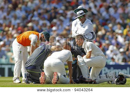 LONDON, ENGLAND - August 21 2013: Shane Watson gets some medical attention  after being hit on the head during day one of the 5th Investec Ashes cricket match between England and Australia