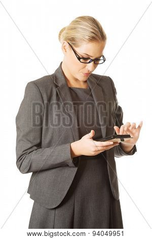 Beautiful businesswoman sending a message