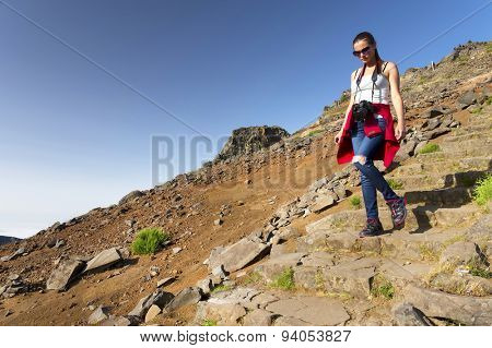 Young girl on the winding mountain trekking path at Pico do Areeiro, Madeira, Portugal