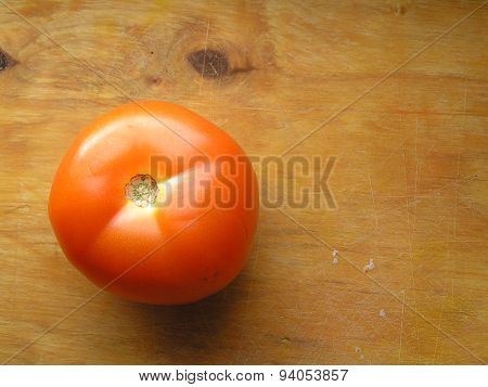 Tomato On Wooden Board