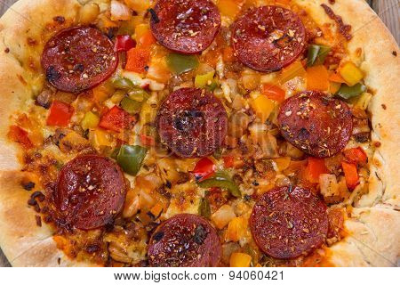 Delicious Baked Salami Pizza Served On Rustic Wooden Table