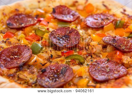 Delicious Baked Salami Pizza Served On Rustic Wooden Table