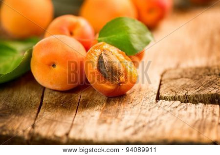 Apricot. Ripe Organic Apricots with leaves on a white wooden table