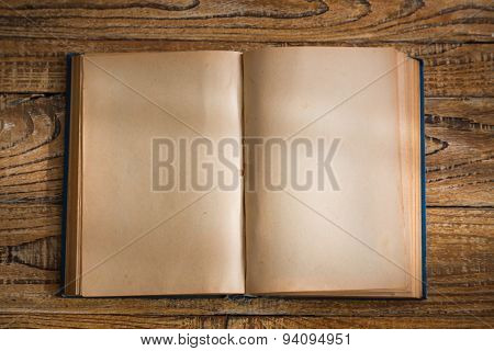 Open blank pages of old book on wood background