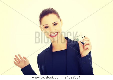 Young businesswoman with plane toy in hand