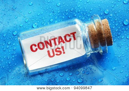 Contact us message in a bottle concept for support, assistance and help