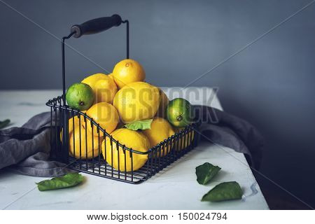 Citrus fruits in bakset on marble table