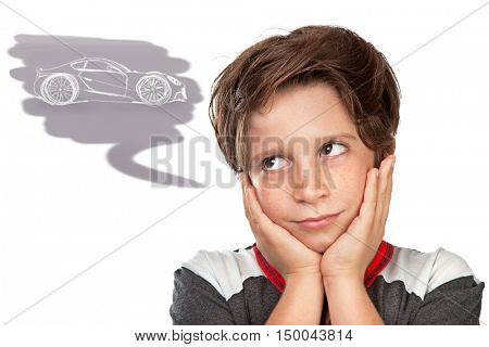 Closeup portrait of a cute teen boy dreaming about a car, thoughtful child isolated on white background, great boyish wish