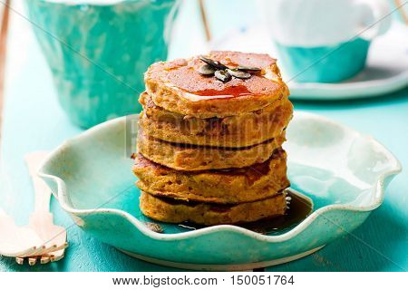 Pumpkin paleo pancakes on blue plate . selective focu