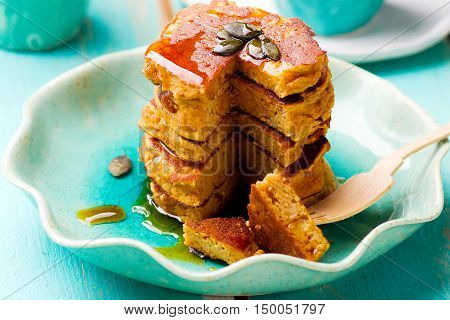 Pumpkin paleo pancakes on blue plate . selective focu