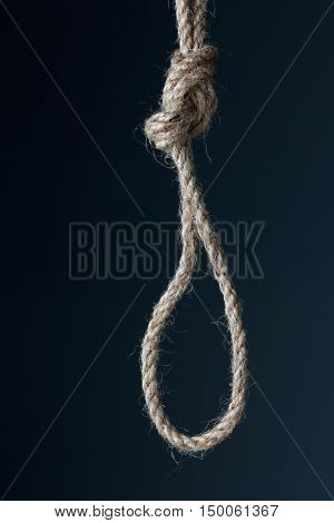 Knot rough jute rope closeup on black background