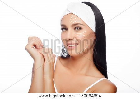 Young Woman in Hairband Touching her Face with a Perfectly Clean Skin. Beautiful Woman Cares for the Skin Face. Skin Care, Cosmetics and Makeup Concept.