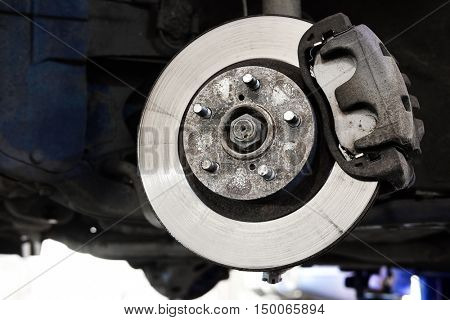 The image of a calliper disk brake close up