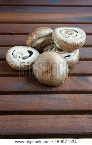 Giant mushrooms Portobello on a wooden table