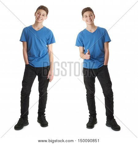 Cute teenager boy in blue T-shirt standing and poinitng forward over white isolated background full body