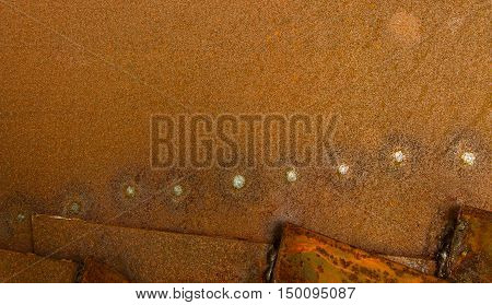 sheet metal somewhat rusty lying one upon another in three layers on one sheet of traces of spot welding in the form of bright points.