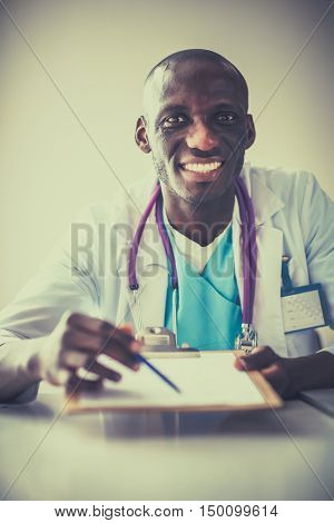 Male doctor sitting at his desk