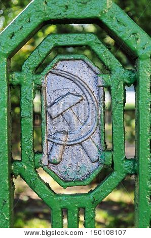 Minsk, Belarus - September 13, 2016: Soviet symbols (hammer and sickle) on the old metal fence