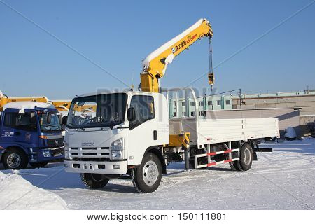 Great white auto truck crane standing on a construction site in winter - Russia Moscow - 21 January 2016