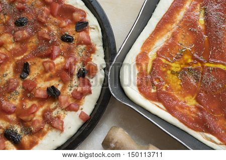 pizza alla marinara with fresh chopped tomatoes anchivies and black olives