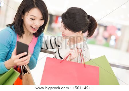 Happy woman shopping selfie and use smart phone in the mall shot in hong kong asian