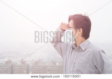 man wear masks and look somewhere with air pollution asian