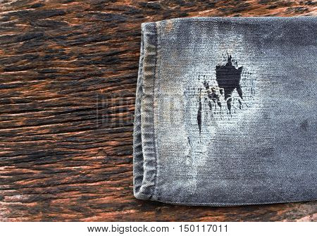old jeans leg on old wood for design.