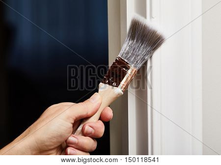 Hand with a paint brush.